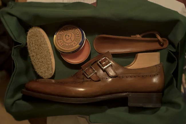Handcrafted leather shoe with care accessories ready for fitting and collection