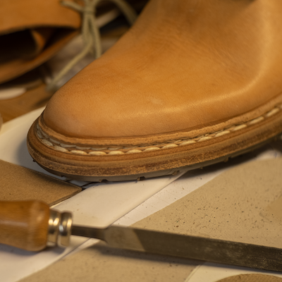 Tan leather boot with hand-stitched sole crafted in Montegranaro, Italy