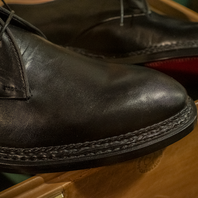 Black handcrafted leather shoe with traditional stitched welt made in Italy